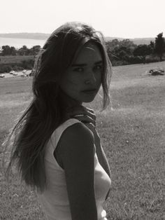 black and white photograph of a woman in a field