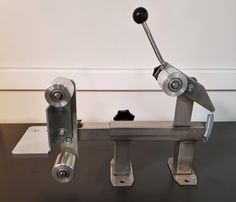 a metal object with two wheels on each end and one wheel attached to the back