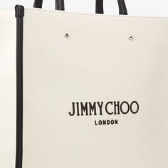 Our N/S Tote provides a departure from the classic tote bags in candy pink canvas. Our signature Jimmy Choo logo brings a touch of distinction to this versatile style that features a long detachable shoulder strap to be worn long or across the body. Practical and functional; it's comfortable to carry with easy interior access. Large Designer Bag With Detachable Handle, Designer Large Bag With Detachable Handle, Designer Large Bags With Detachable Handle, Designer Canvas Bag With Top Carry Handle For Errands, Designer Canvas Bag With Top Handle For Daily Use, Designer Canvas Bag With Double Handle For Errands, Designer Double Handle Canvas Bag For Errands, Designer Medium Shopping Bag, Designer Rectangular Canvas Bag For Errands