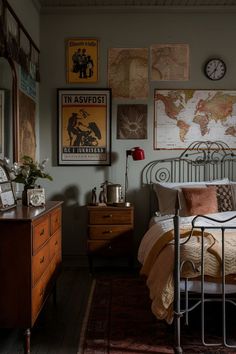 a bed room with a neatly made bed and lots of pictures on the wall