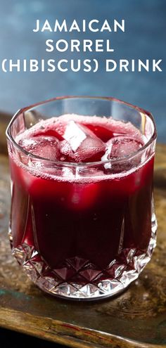 a drink in a glass with ice cubes on the rim and text that reads jamaican sorrel chibuscusi drink