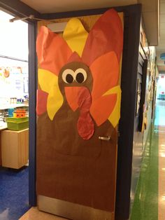 a door decorated to look like a turkey with a big nose and large tail on it