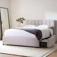 a bed sitting on top of a white rug in a bedroom