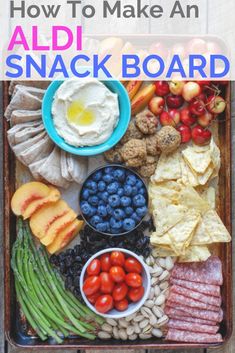 a tray filled with different types of food and the words how to make an aldi snack board