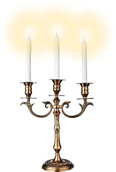 three candles are lit on an antique brass candelabra