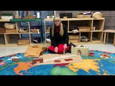 a woman sitting on the floor in front of boxes