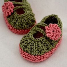 two crocheted baby shoes with pink and green flowers