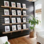 a living room filled with white furniture and pictures on the wall above it's shelves