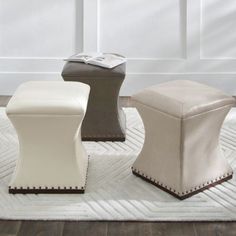 three stools sitting on top of a white rug