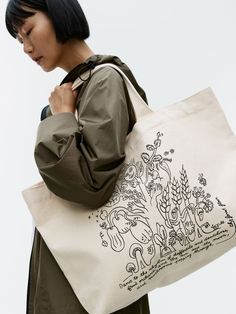 Roomy tote made from cotton canvas. Detailed with both short handles and shoulder straps for versatile carrying. Printed motif on one side, and text print on the other. Dimensions 38 cm x 14 cm x 46 cm.  This product is part of the ARKET CAFÉ collection featuring illustrations by Olga Prader. Arket Café, Other Dimensions, Text Print, Classic Wardrobe, Trainer Boots, New Sneakers, Small Accessories, Jean Leggings, Jacket Sale