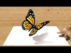 a hand holding a pencil drawing a yellow butterfly on top of a piece of paper