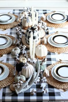 the table is set with white and black dishes