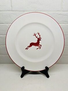 a red and white plate with a deer on it