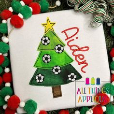 a christmas tree with soccer balls on it is surrounded by pom - poms