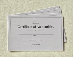 three certificates on top of each other with the words certificate of authenticity in black and white