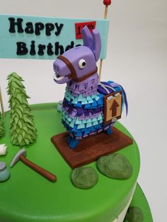 a birthday cake with a horse on top and a happy birthday sign in the background