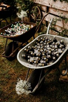 a wheelbarrow filled with lots of beer bottles