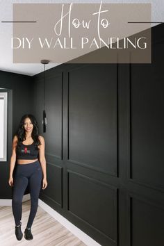 a woman standing in front of black walls with the words how to diy wall paneling