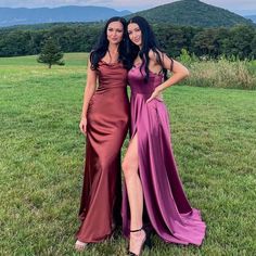 two women standing next to each other in a field