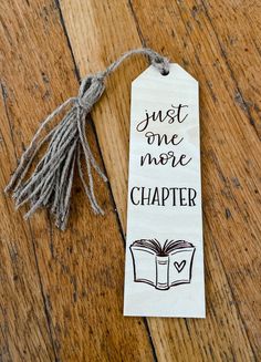 a bookmark with the words just one more chapter on it and a tassel