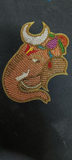 an embroidered bull head on a black surface