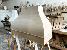 a large wooden boat being built in a woodworking shop with lots of work on the table