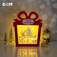 an illuminated christmas gift box sitting on a table