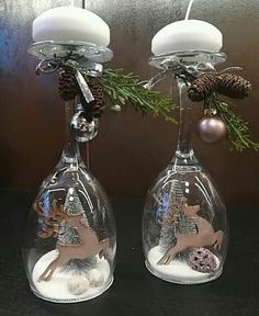 two wine glasses with christmas decorations on them