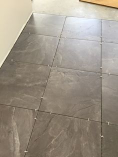 a tile floor in a kitchen with white walls