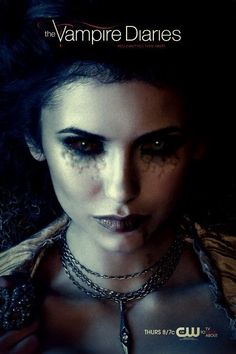 a poster for the vampire diaries with a woman's face covered in makeup