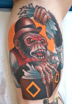 a tattoo on the leg of a person with a monkey holding a knife and fork