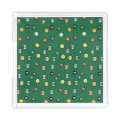 a green background with lots of different colored balls and numbers on the bottom, all in clear acrylic