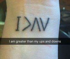 a wrist tattoo with the words i am greater than my ups and downs