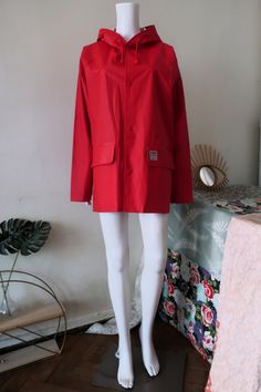 Beautiful Vintage Helly Hansen raincoat from the 1990s. Red PVC-coated fabric, straight cut. Wide generous raglan sleeves with size adjustable cuffs. Hood with drawstring. Snap button closure, branded buttons. Two flap front pockets, Helly Hansen brand label on the left flap. Unlined. Unisex. Made in Portugal! BRAND: Helly Hansen ERA: 1990s COLOR: Red FABRIC: Face 100% PVC, back 100% polyester SIZE: Vintage size S, men's 46-48, women's 40-42 - it's gender neutral and fits best a women's size M-L Red Winter Raincoat, Red Long Sleeve Raincoat For Winter, Red Hooded Raincoat For Outdoor, Red Hooded Raincoat For Fall, Raincoat With Hood, Red Raincoat, Hooded Raincoat, Pvc Coat, Brand Label