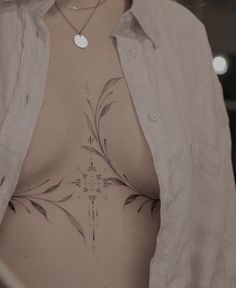 a woman with tattoos on her chest