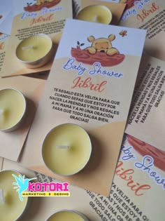 several small candles sitting on top of each other in front of a card with the words baby shower