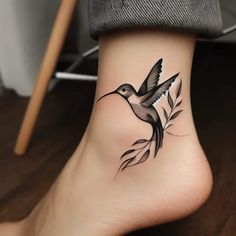 a small bird tattoo on the ankle