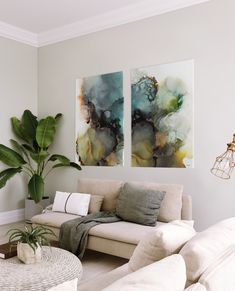 a living room with two paintings on the wall