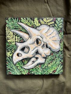 a painting of a skull in the middle of some leaves and plants on a green background