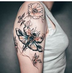 a woman's arm with flowers on it