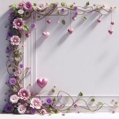 a white frame with pink flowers and hearts hanging from it's sides on a wall