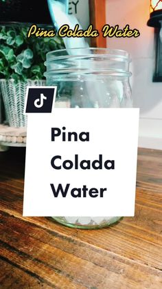 a jar filled with water sitting on top of a wooden table