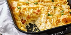 a casserole dish in a black pan with green garnish on top