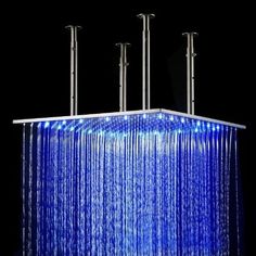 a shower head with blue lights on the side and water running down it's sides