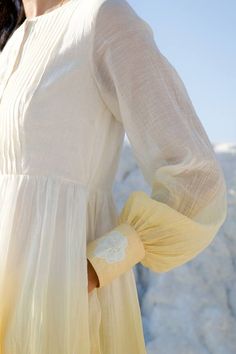 White, yellow tiered dress with embroidered petal flower and knife pleats on the bodice.
Component: 1
Neckline: Boat neck
Sleeve Type: Balloon
Fabric: Handwoven Chanderi Silk
Color: White, Yellow
Other Details: 
Pockets on the side
Broad cuffs
Occasion: Party - Aza Fashions Loom Art, Knife Pleats, Petal Flower, Tiered Dress, Dress For Women, The Loom, Button Placket, Aza Fashion, Boat Neck