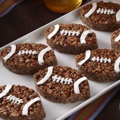 six cookies in the shape of footballs on a tray