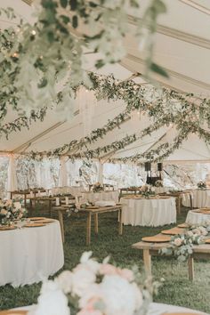 an instagram photo taken from the inside of a tent with tables and chairs