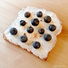 a piece of bread topped with blueberries and cream