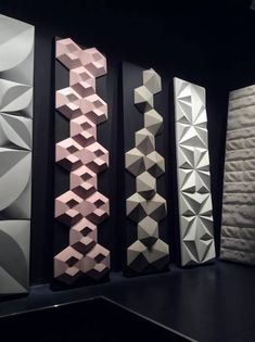 an array of different shapes and sizes of wall panels on display in a dark room