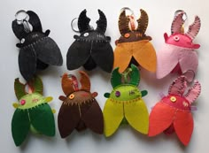 several different types of stuffed animals are shown in the shape of fish or squids